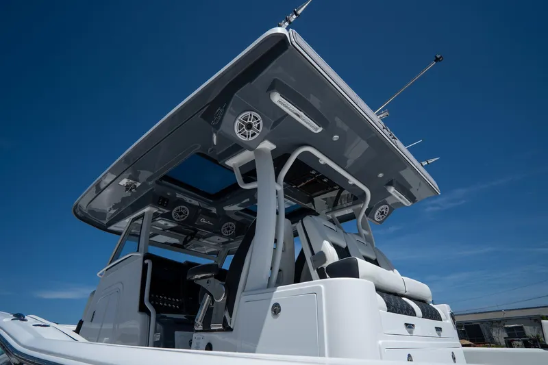 Slide: The Image of 2023 Tidewater 380 CC Adventure boat docked in a serene marina setting. - 4