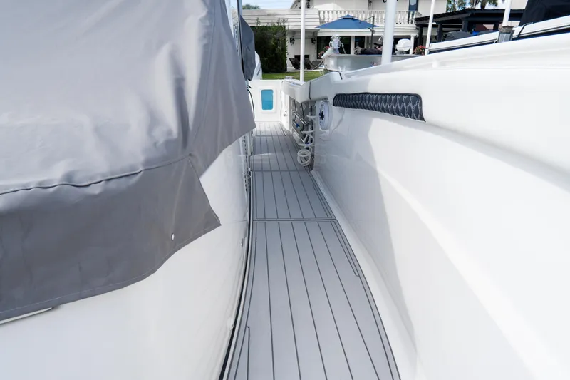 Slide: The Image of 2023 Tidewater 380 CC Adventure boat deck with custom "The Reel Deal" design. - 43