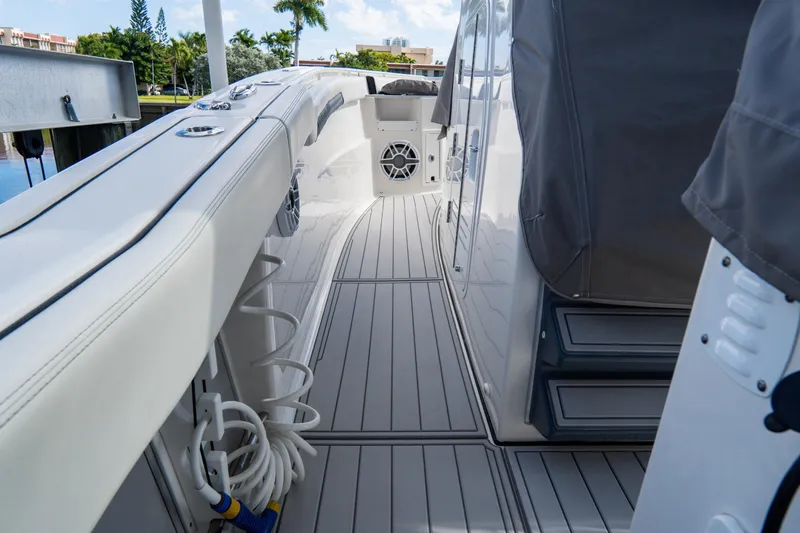 Slide: The Image of 2023 Tidewater 380 CC Adventure boat deck with "The Reel Deal" logo. - 44