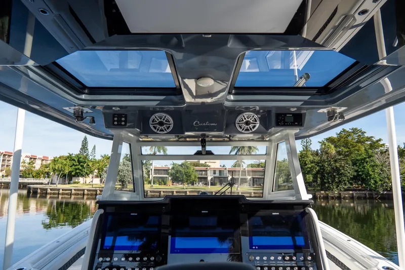 Slide: The Image of 2023 Tidewater 380 CC Adventure boat cockpit with advanced navigation and audio systems. - 45