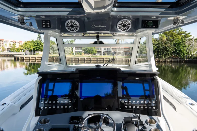 Slide: The Image of 2023 Tidewater 380 CC Adventure boat cockpit with advanced navigation displays and controls. - 46