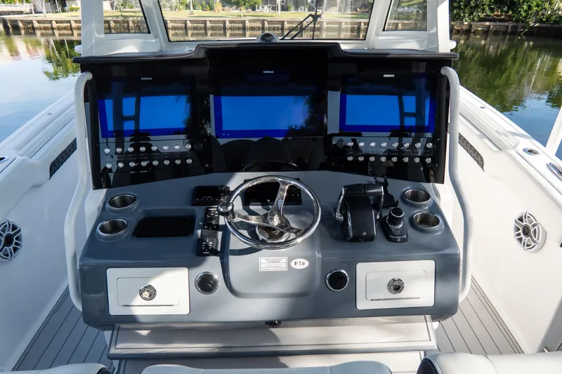 Slide: The Image of 2023 Tidewater 380 CC Adventure boat dashboard with advanced navigation displays and controls. - 47