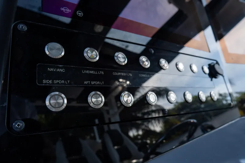Slide: The Image of Control panel of 2023 Tidewater 380 CC Adventure boat with labeled buttons. - 49