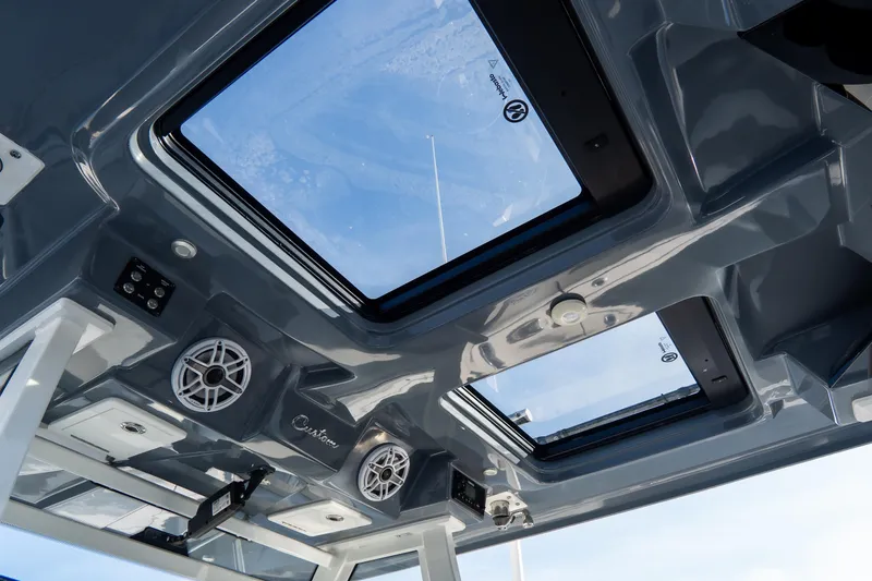 Slide: The Image of Interior view of 2023 Tidewater 380 CC Adventure boat's ceiling with skylights and speakers. - 51
