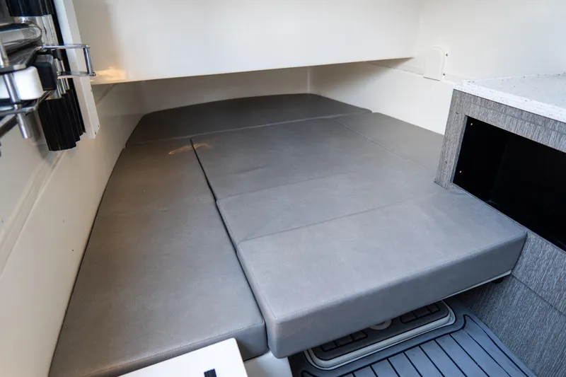 Slide: The Image of 2023 Tidewater 380 CC Adventure cabin interior with cushioned seating and storage. - 57