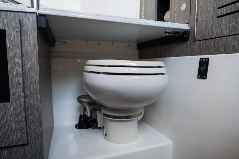 Slide: The Image of 2023 Tidewater 380 CC Adventure boat interior with modern marine toilet. - 60