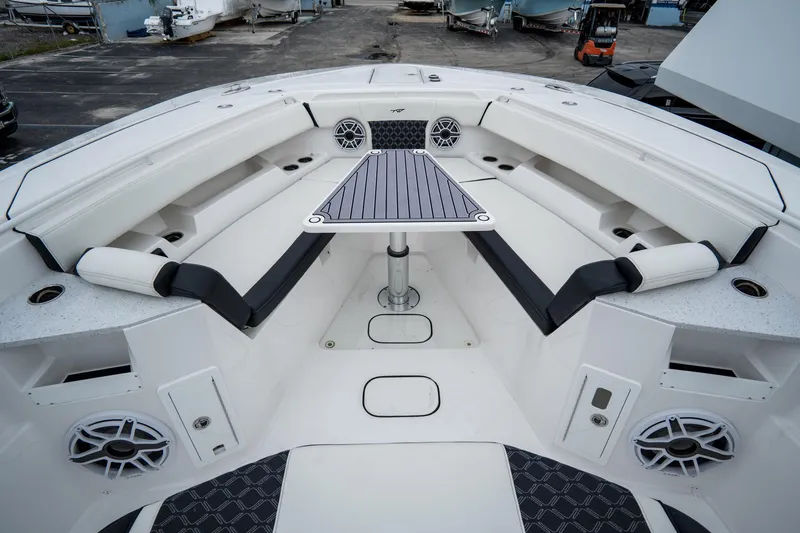 Slide: The Image of 2023 Tidewater 380 CC Adventure boat interior with seating and table. - 65