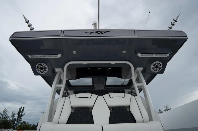 Slide: The Image of 2023 Tidewater 380 CC Adventure boat docked, aerial view, sleek design, spacious seating. - 7