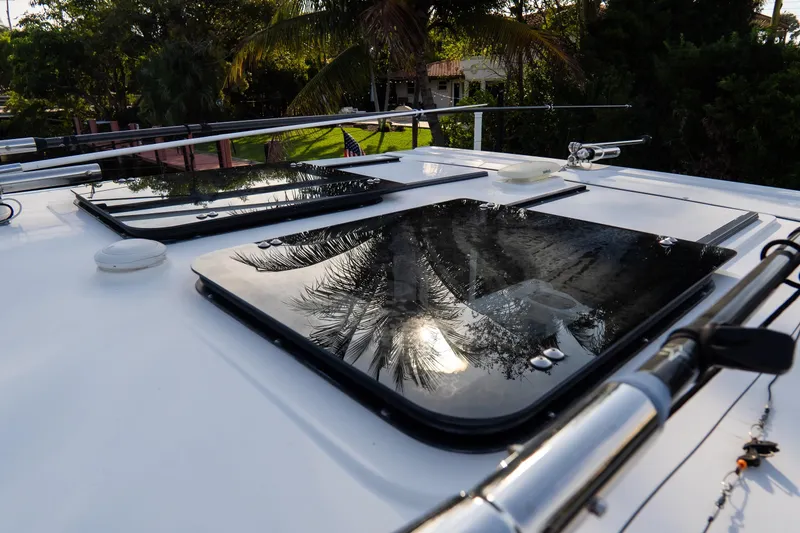 Slide: The Image of 2023 Tidewater 380 CC Adventure boat roof with hatches and fishing rods. - 77