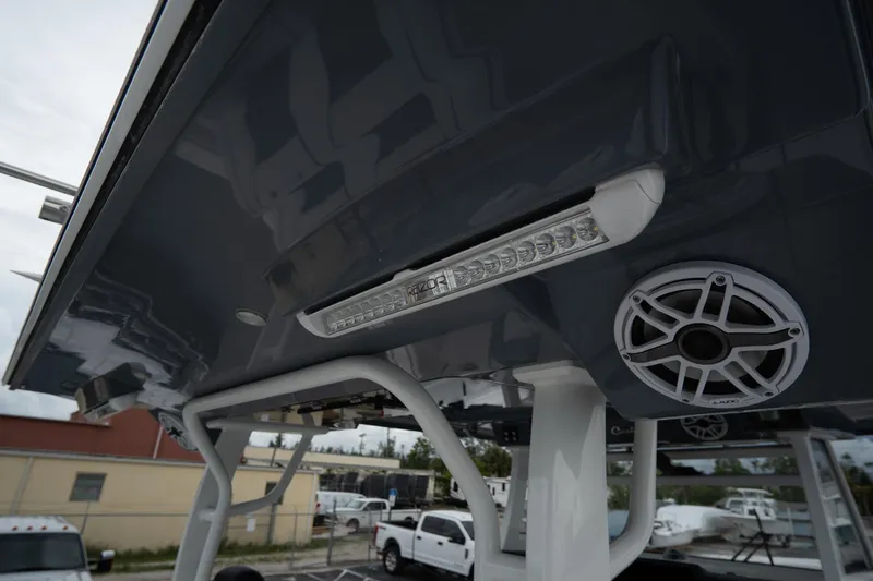 Slide: The Image of 2023 Tidewater 380 CC Adventure boat docked, showcasing spacious seating and sleek design. - 8