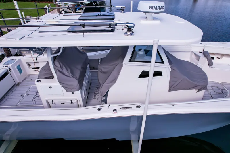 Slide: The Image of 2023 Tidewater 380 CC Adventure boat with covered seating and advanced navigation equipment. - 81