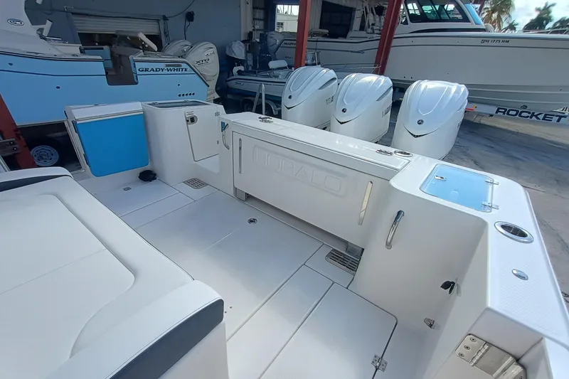 Slide: The Image of 2026 Robalo R360 Center Console boat interior with triple outboard engines. - 11