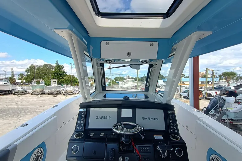 Slide: The Image of 2026 Robalo R360 Center Console boat interior with Garmin navigation system. - 13