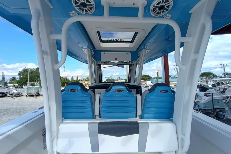 Slide: The Image of 2026 Robalo R360 Center Console boat interior with blue seating and Garmin equipment. - 14