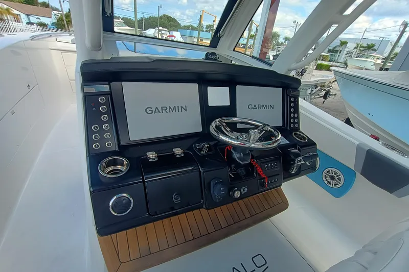 Slide: The Image of 2026 Robalo R360 Center Console helm with dual Garmin displays and modern controls. - 15