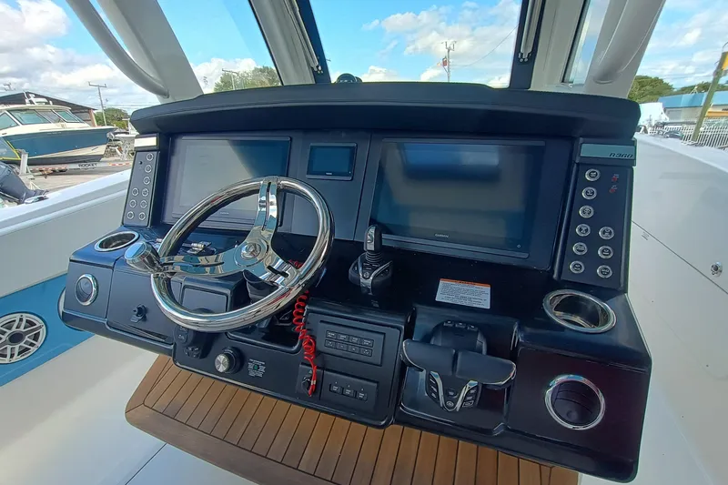 Slide: The Image of 2026 Robalo R360 Center Console dashboard with steering wheel and navigation screens. - 17