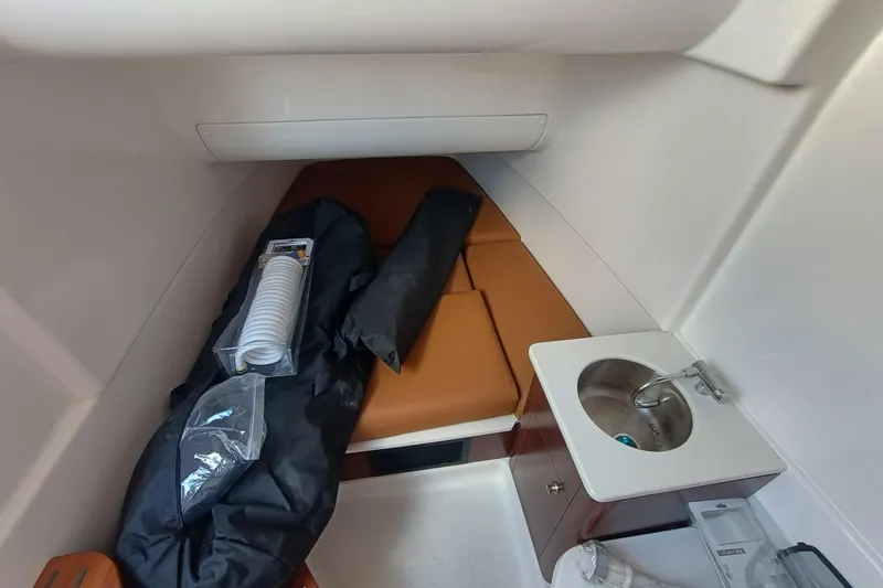 Slide: The Image of 2026 Robalo R360 Center Console cabin interior with sink and storage. - 21