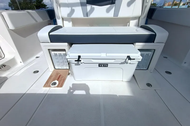 Slide: The Image of 2026 Robalo R360 Center Console boat interior with Yeti cooler and seating area. - 32