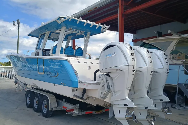 Slide: The Image of 2026 Robalo R360 Center Console boat with triple Yamaha 350 engines on a trailer. - 6