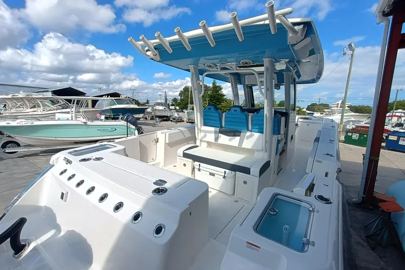 Slide: The Image of 2026 Robalo R360 Center Console boat with blue seating and spacious deck. - 8