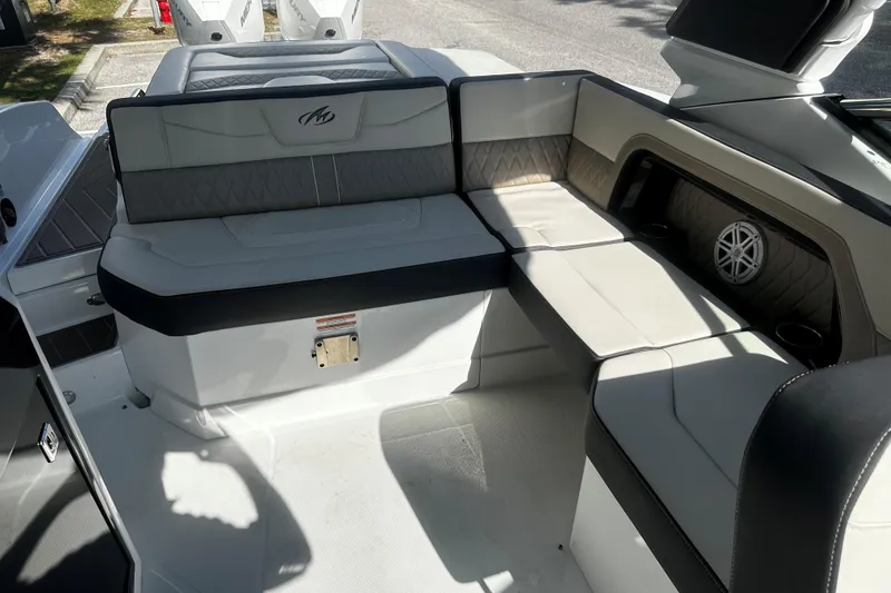 Slide: The Image of 2023 Monterey 305SS Super Sport boat interior with cushioned seating and speaker system. - 11