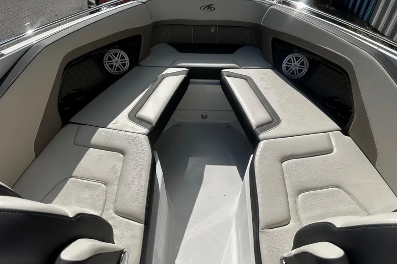 Slide: The Image of 2023 Monterey 305SS Super Sport boat interior with cushioned seating and speakers. - 14