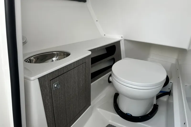 Slide: The Image of 2023 Monterey 305SS Super Sport boat bathroom with sink and toilet. - 15