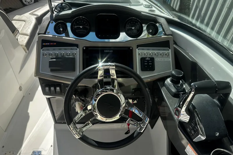 Slide: The Image of Cockpit of 2023 Monterey 305SS Super Sport boat with modern controls and steering wheel. - 17