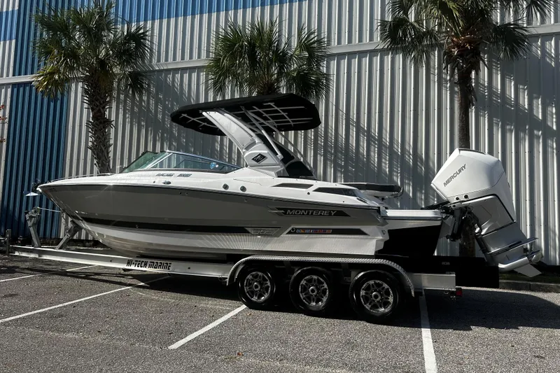 Slide: The Image of 2023 Monterey 305SS Super Sport boat on trailer, parked near palm trees. - 3