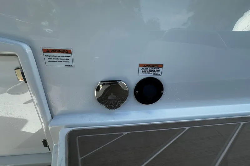 Slide: The Image of 2023 Monterey 305SS Super Sport boat with warning labels and deck details. - 5