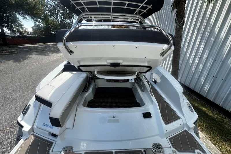 Slide: The Image of 2023 Monterey 305SS Super Sport boat with open storage compartment, sleek design. - 6