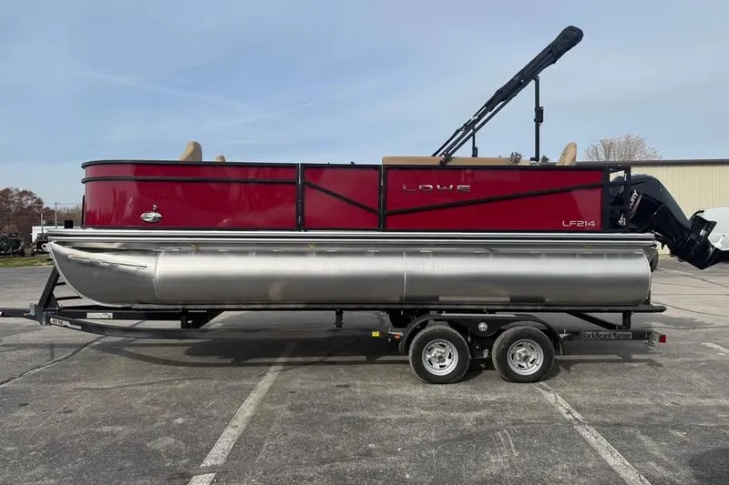 The Image of 2026 Lowe LF 214 pontoon boat on trailer, red and silver design. - 0