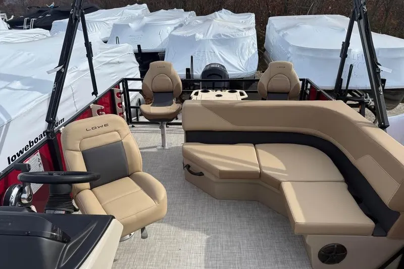 Slide: The Image of 2026 Lowe LF 214 boat interior with beige seating and steering wheel. - 11