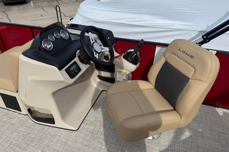 Slide: The Image of 2026 Lowe LF 214 boat interior with steering console and beige captain's chair. - 12