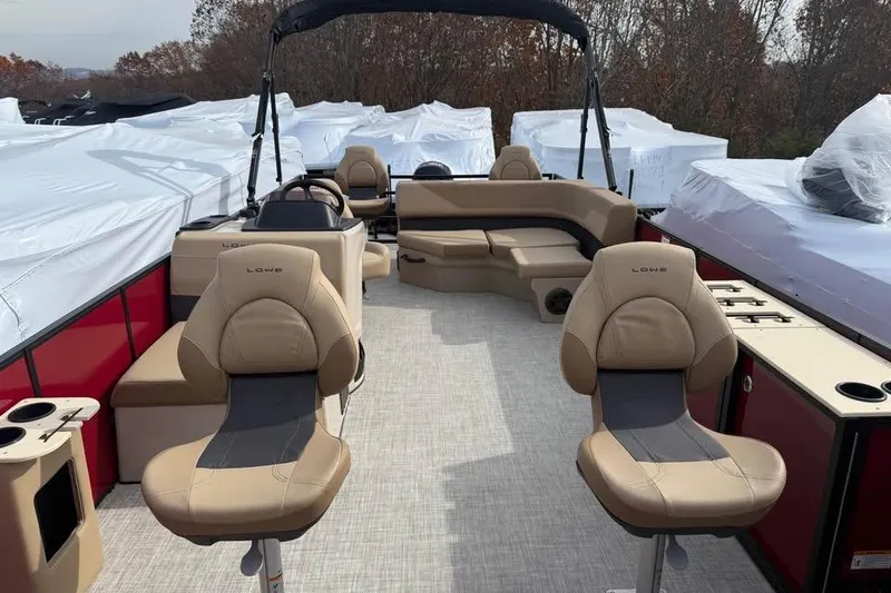 Slide: The Image of 2026 Lowe LF 214 pontoon boat interior with beige seating and red accents. - 15