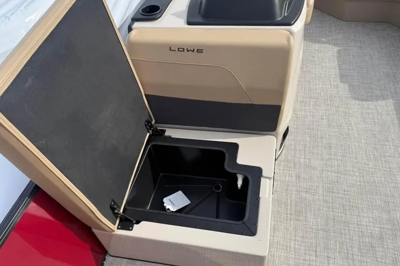 Slide: The Image of Open storage compartment on 2026 Lowe LF 214 boat, featuring beige and black design. - 16