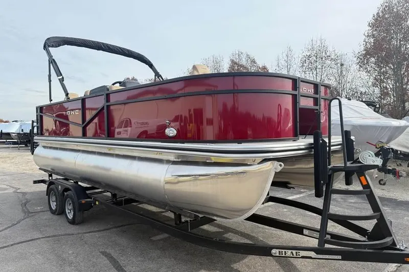Slide: The Image of 2026 Lowe LF 214 pontoon boat on trailer, featuring sleek red design. - 3