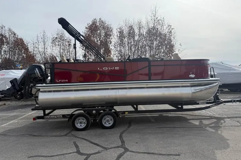 Slide: The Image of 2026 Lowe LF 214 pontoon boat on trailer, parked outdoors. - 4