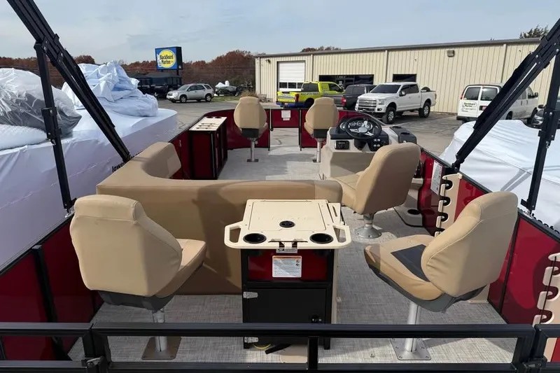 Slide: The Image of 2026 Lowe LF 214 pontoon boat interior with beige seating and steering console. - 9
