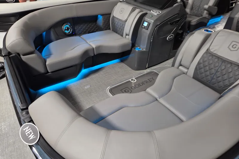 Slide: The Image of Luxurious 2026 Godfrey SA boat interior with plush seating and ambient blue lighting. - 2