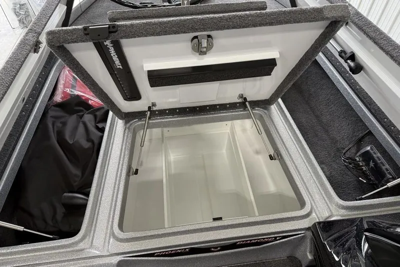 Slide: The Image of Open storage compartment in 2025 Phoenix 920 Elite II boat, featuring spacious interior. - 10