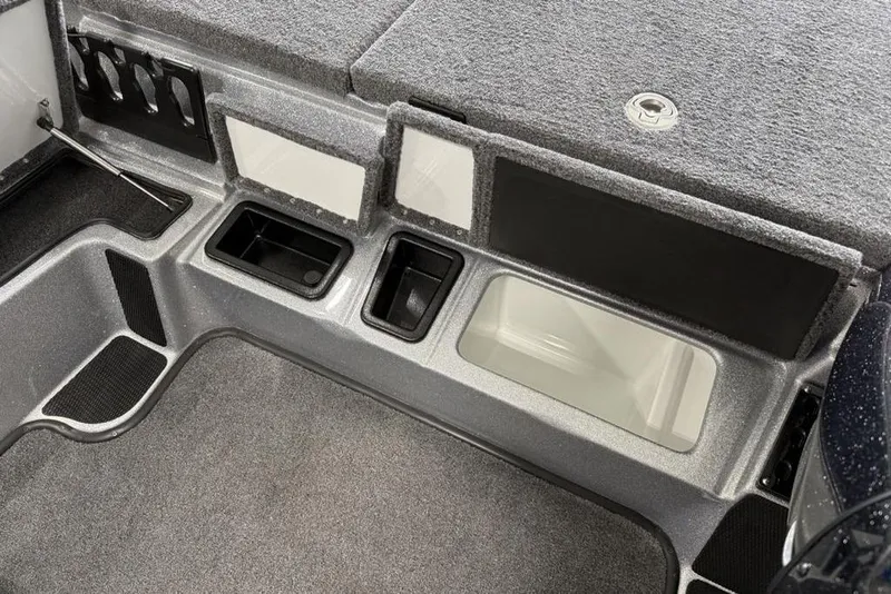 Slide: The Image of 2025 Phoenix 920 Elite II boat interior with storage compartments and carpeted flooring. - 12