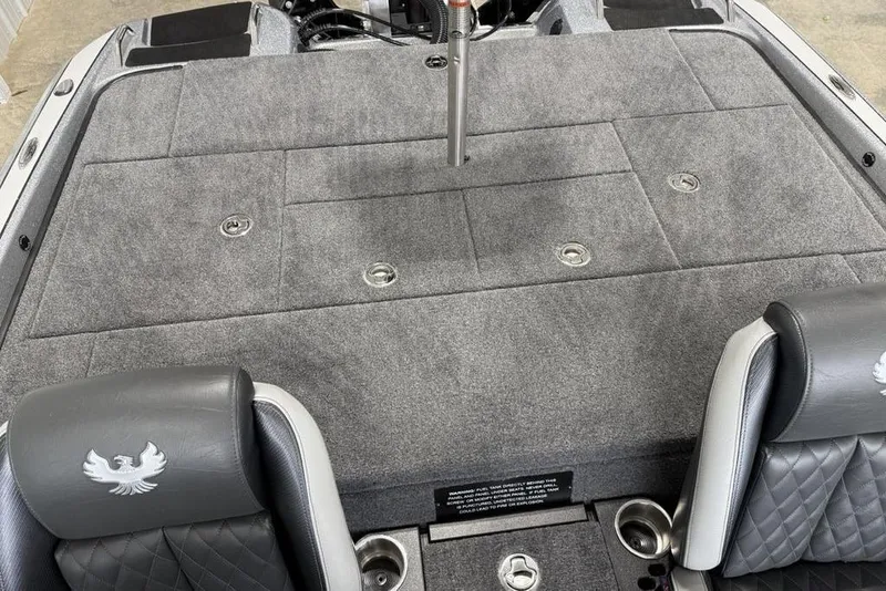Slide: The Image of 2025 Phoenix 920 Elite II boat interior with gray carpet and leather seats. - 18