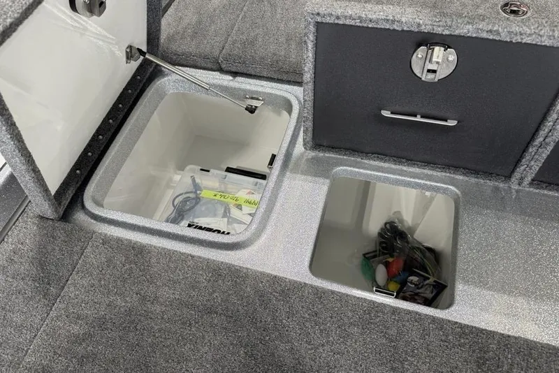 Slide: The Image of Storage compartments in a 2025 Phoenix 920 Elite II boat, featuring organized interior spaces. - 19