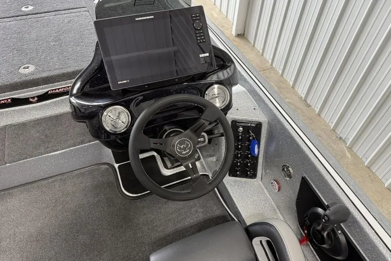Slide: The Image of 2025 Phoenix 920 Elite II boat dashboard with steering wheel and electronic display. - 20