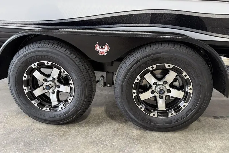 Slide: The Image of Dual wheels of a 2025 Phoenix 920 Elite II trailer with stylish rims and logo. - 3