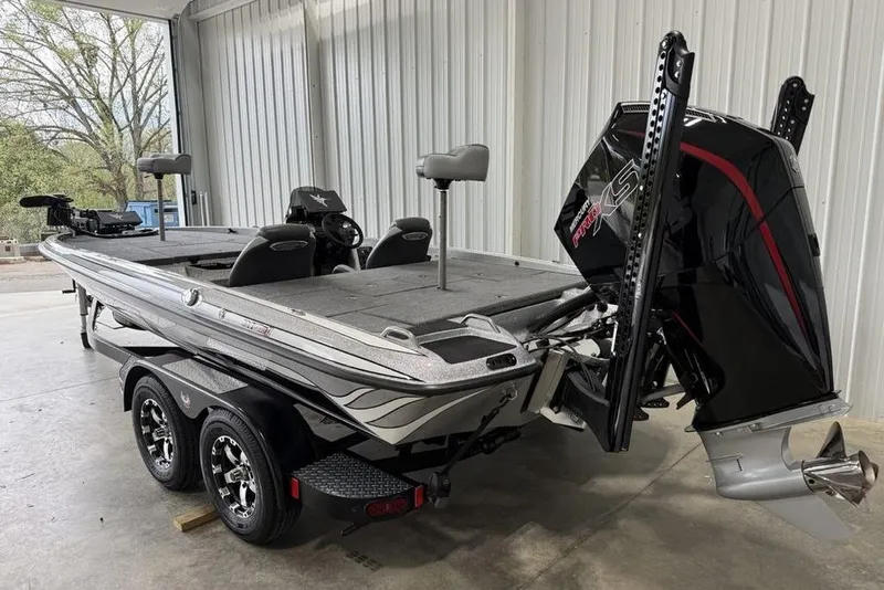 Slide: The Image of 2025 Phoenix 920 Elite II boat in garage, featuring sleek design and powerful engine. - 4