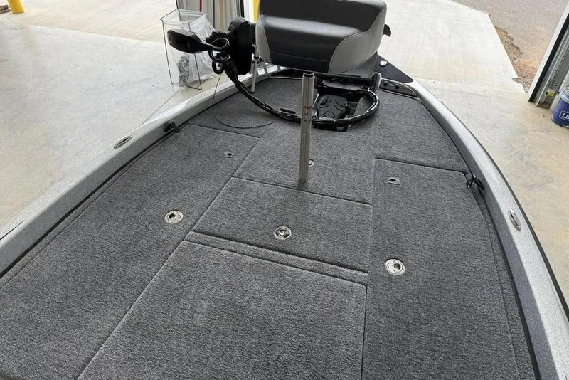 Slide: The Image of 2025 Phoenix 920 Elite II boat deck with gray carpet and seating. - 5