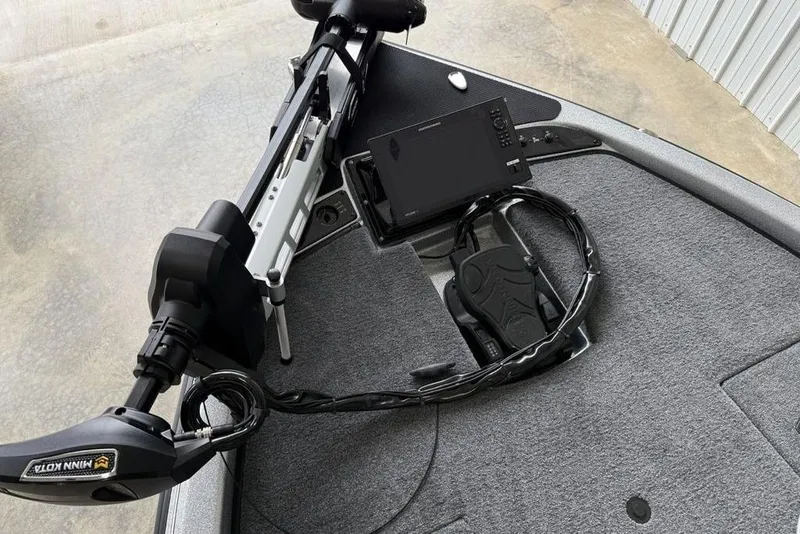 Slide: The Image of 2025 Phoenix 920 Elite II boat deck with Minn Kota trolling motor and control panel. - 9