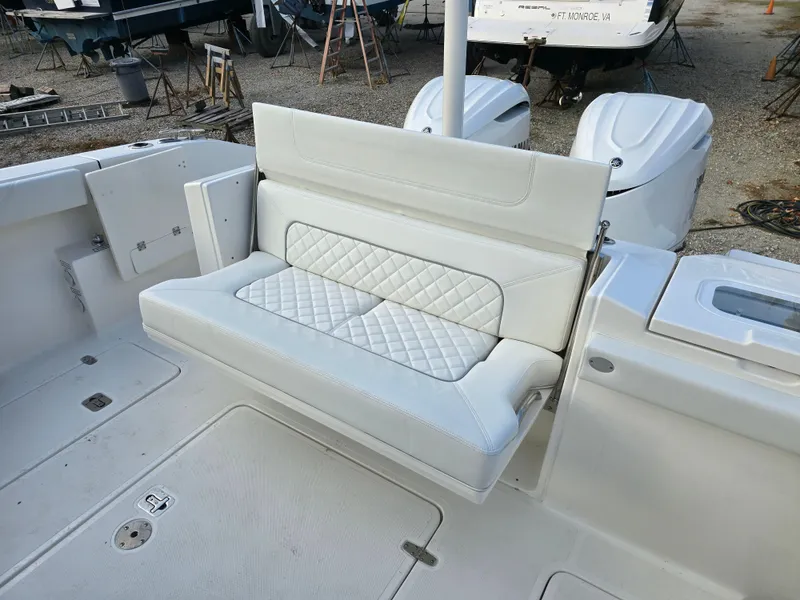 Slide: The Image of 2025 Pursuit S 328 boat with white cushioned seating and diamond pattern design. - 7